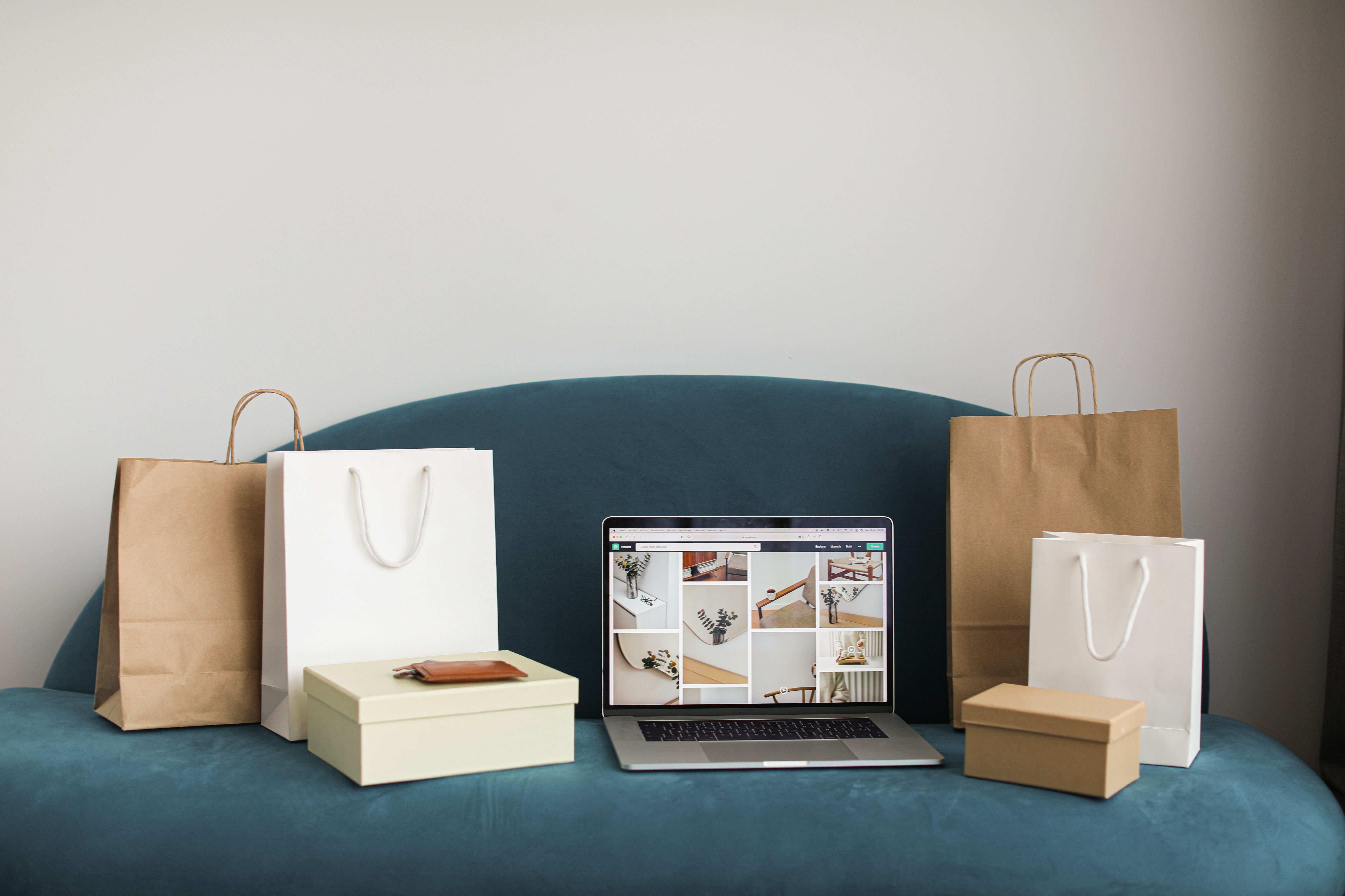 Shopping bags and a laptop arranged for an e-commerce concept